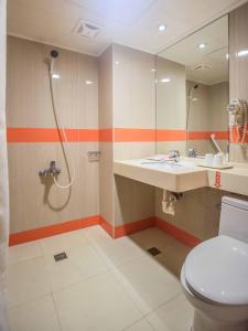 a bathroom with a shower and a toilet and a sink at KKS Hotel in Hualien City +39 photos