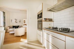 a kitchen with white appliances and a living room at 4SONS UMAG Sea View 2BR Apartment in Town center !NEW! in Umag