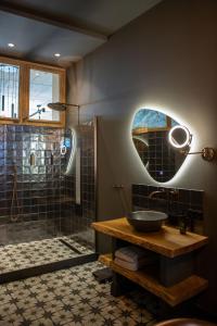 a bathroom with a sink and a glass shower at Het Maashuys in Arcen +35 photos