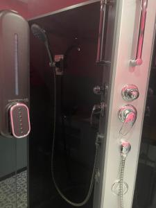 a shower in a bathroom with a phone at Cherry Apart Legionów 24 in Łódź +6 photos