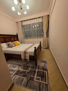 a bedroom with a bed and a window at C7 Haven Artesano in Nairobi