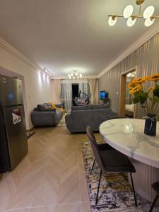 a living room with a table and a couch at C7 Haven Artesano in Nairobi