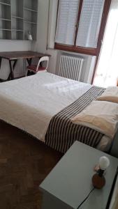 Ένα ή περισσότερα κρεβάτια σε δωμάτιο στο Rinidia - Siena Celso Cittadini Grande