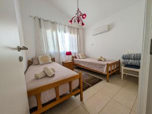 En eller flere senge i et værelse på Fig Tree Bay Villa Elena + 22 billeder