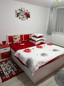 a bedroom with a bed with flowers on it at Cabana Acasă la Delia in Gîrda de Sus +35 photos