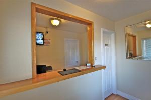 a mirror on a wall in a room with a desk at Budget Inn in Lompoc