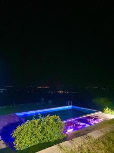 a swimming pool at night with purple lights at Lernarot Guest House in Lernarot +15 photos