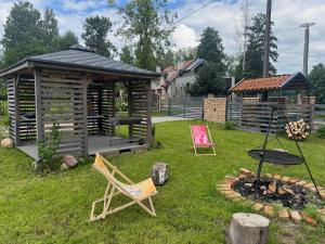 a backyard with a gazebo and a fire pit at Borowe Apartamenty in Borowe