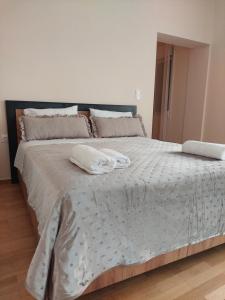 a bedroom with a large bed with two pillows on it at Natasa's Appartment in Kalamata in Kalamata