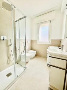 a bathroom with a shower and a toilet and a sink at Verga - 100 m da Piazza Mazzini - Immobil Relax in Lido di Jesolo