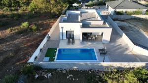 an aerial view of a house with a swimming pool at Villa Zara Blu with pool in Briševo
