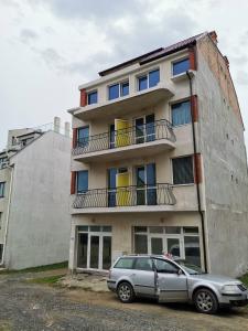 a car parked in front of a building at Стаи за гости Кирови in Ahtopol +7 photos