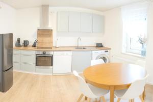 a kitchen with a wooden table and white appliances at Dein Ferienhaus in Andernach