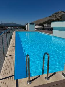 a large blue swimming pool on top of a building at Apartman PORTO in Trebinje