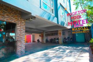a store front of a hotel with motorcycles parked outside at MANGAL RESIDENCY Mountain View- A Luxury Boutique Business Hotel in Bedla