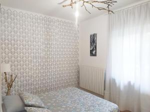 a bedroom with a bed and a wall at Villa dei Fiori in Luino