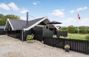 VestervigにあるCozy Home In Vestervig With Wifiの黒塀と傘の家