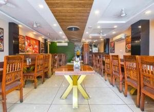 a dining room with a table and wooden chairs at MANGAL RESIDENCY Mountain View- A Luxury Boutique Business Hotel in Bedla