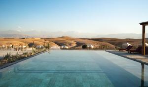 a large swimming pool in the middle of a desert at Inara Camp in El Karia