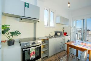 a kitchen with a stove and a sink at Mandilara Minimal Apartment in Rhodes Town