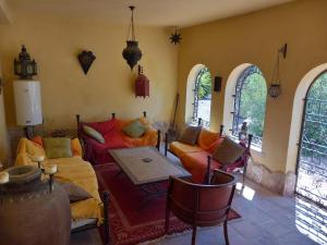 a living room with orange couches and a table at Casa Castor Catral in Crevillente