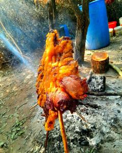 a piece of meat is cooking on a grill at Mara Sidain lodge in Sekenani