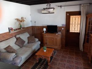 a living room with a couch and a tv at Casa Castor Catral in Crevillente
