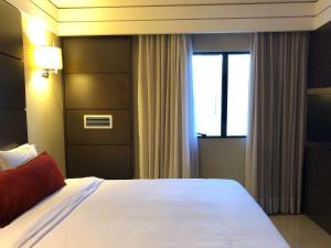 Ein Bett oder Betten in einem Zimmer der Unterkunft Mercure Camboriu