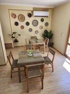 a dining room with a table and chairs and plates on the wall at Oasis Boutique in Bukhara +44 photos