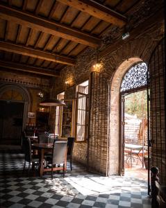 a dining room with a table and chairs in a building at El Castell Embruixat in Saint-Hippolyte