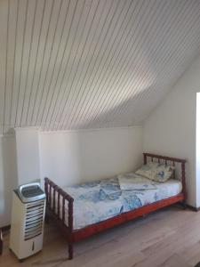 a bed in a room with a white ceiling at Сдам дом сруб посуточно у моря в Совиньоне с верандой in Odesa