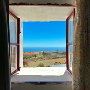 an open window with a view of the ocean at Las Casitas - Casa Higo in Granadilla de Abona +25 photos
