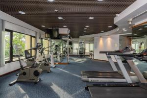 a gym with treadmills and elliptical machines at Grand Diamond Suites Hotel in Bangkok