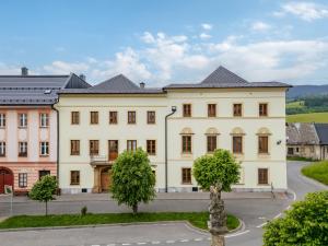 a large white building with trees in front of it at Hotel Pohoda in Staré Město