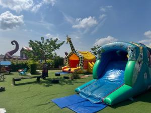 a playground with a inflatable slide in a park at Le Dugny'tique, un endroit fantastique ! in Onzain