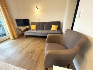 a living room with a couch and a television at Gasthof Post in Stanzach