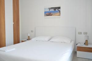 Un dormitorio con una cama blanca y un cuadro en la pared. en Aquamarine Apartments 1, VLORE, en Vlorë 46 fotos más