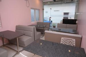 a room with couches and tables in a store at Chandana green view resort Hampi in Gangāwati