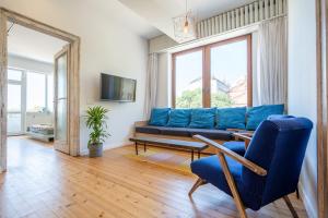 a living room with a blue couch and a table at Bright & Central 2BR in Historic Heart of Sofia in Sofia
