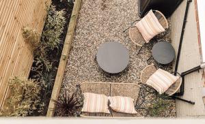 an overhead view of a patio with chairs and a table at Boho Bay One - Seaside Escape in Cullercoats
