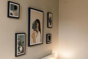 a group of framed pictures on a wall at Boho Bay One - Seaside Escape in Cullercoats