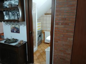 a bathroom with a toilet and a brick wall at Casa dalle valli del castello in Ioppolo Giancaxio +61 photos