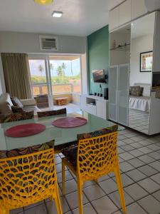 a living room with a table and two chairs at Gavoa Beach Resort Flat 201 D - Praia de Mangue Seco, Igarassu-Pe in Igarassu