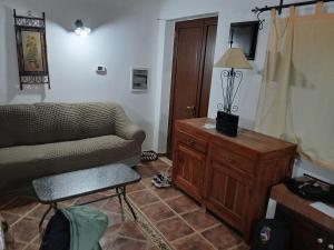 a living room with a couch and a chair at Casa dalle valli del castello in Ioppolo Giancaxio