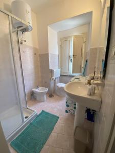a bathroom with a sink and a shower and a toilet at Casa Cindy in Lamezia Terme