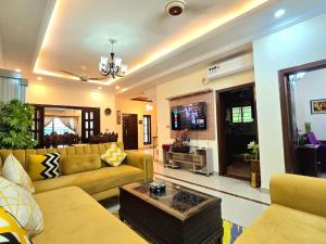 a living room with a couch and a table at 4 Bedroom Holiday Home In Bahria Town Phase 3 in Rawalpindi