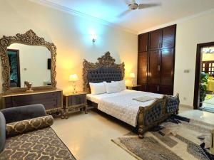 a bedroom with a bed and a large mirror at 4 Bedroom Holiday Home In Bahria Town Phase 3 in Rawalpindi