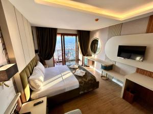 a hotel room with a bed and a balcony at Castello By Mediterra Hotel in Alanya +27 photos