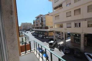 a view of a city street from a balcony at La Dolce Vita Civitavecchia in Civitavecchia