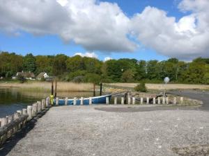 a body of water with a dock next to the water at 4 person holiday home in Skibby in Skibby +24 photos